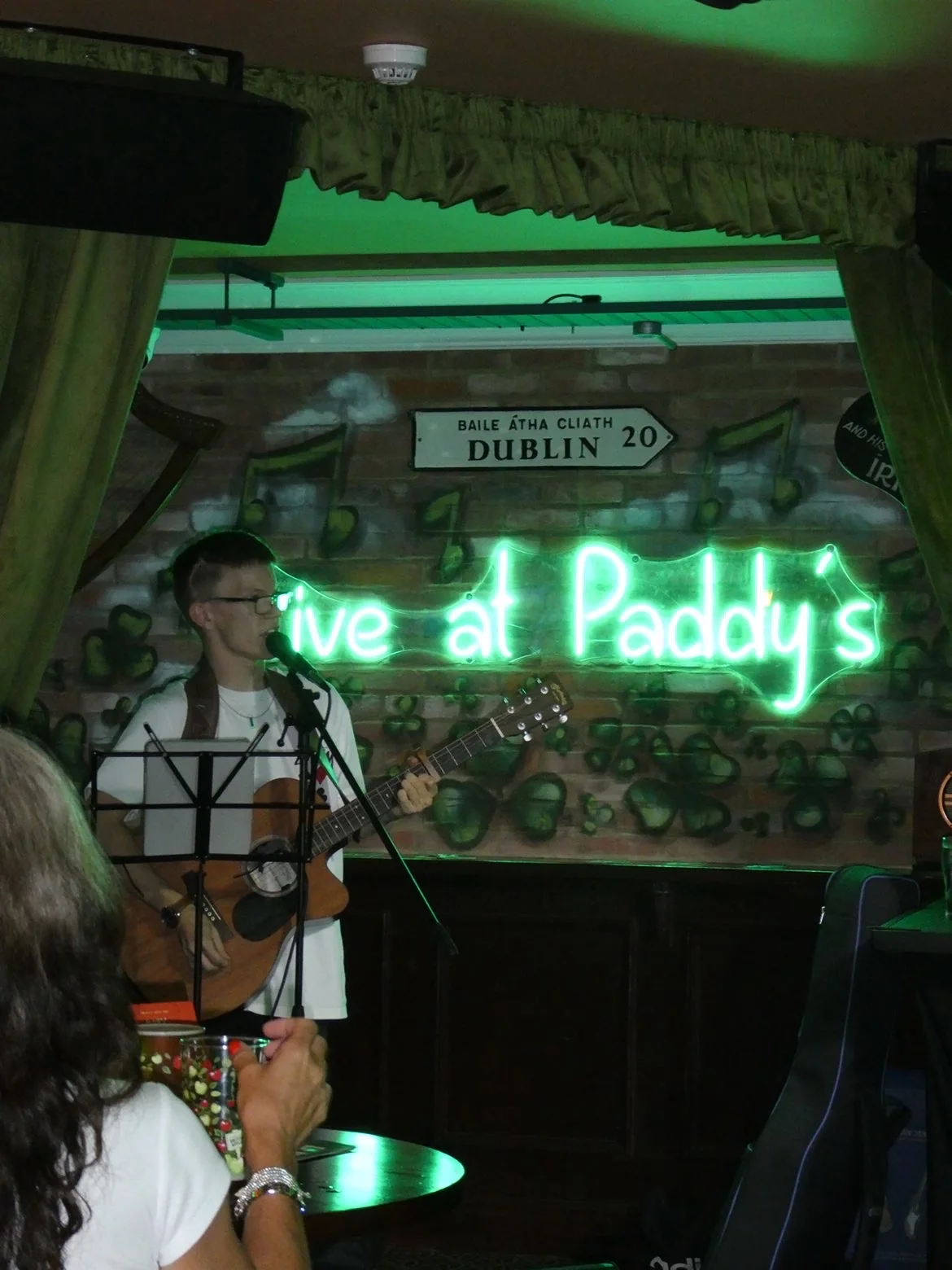 Harry singing and playing guitar at Paddy’s